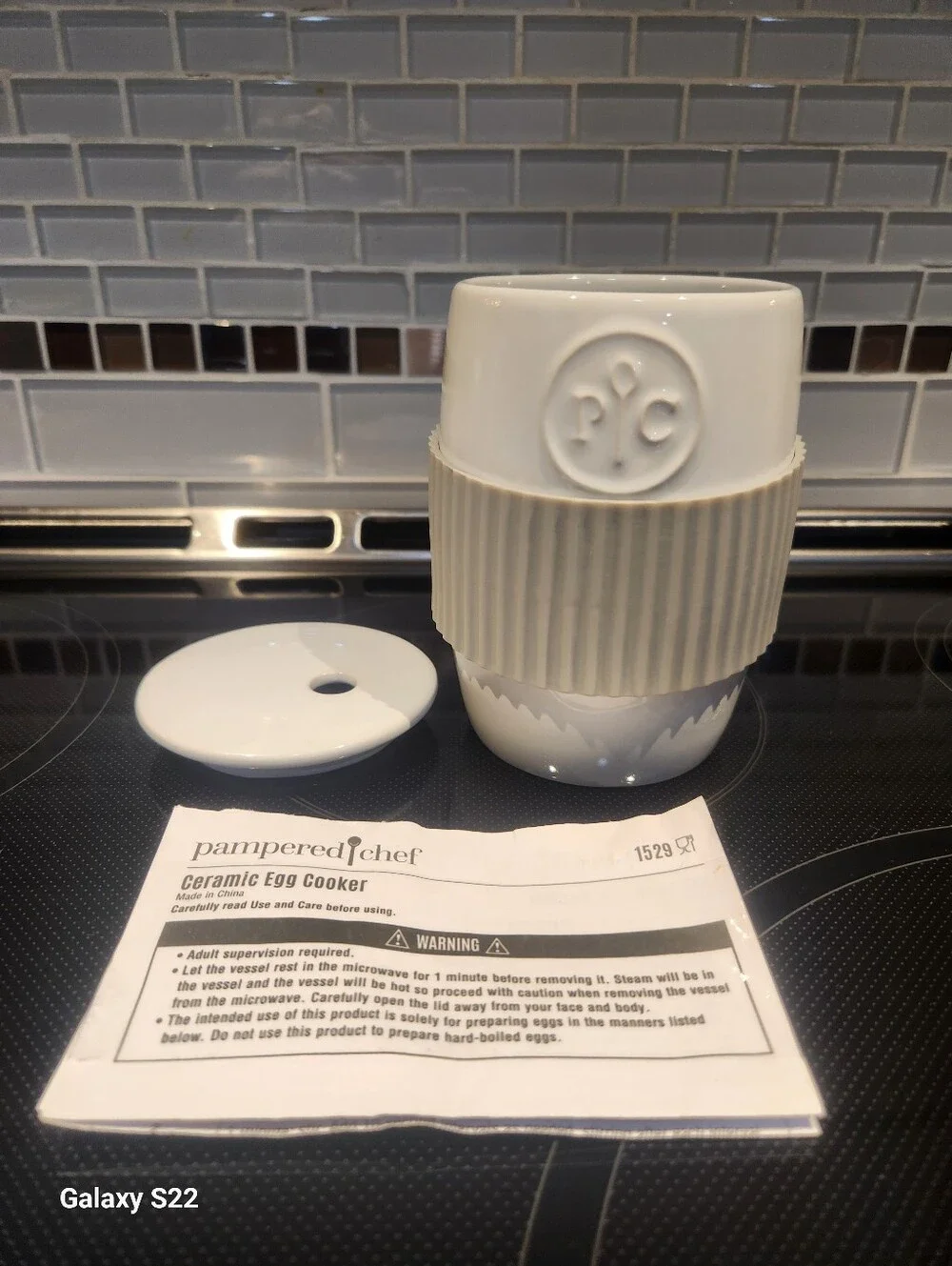 Pampered Chef- White Ceramic Egg Cooker With Gray Silicone Gripper And Lid.